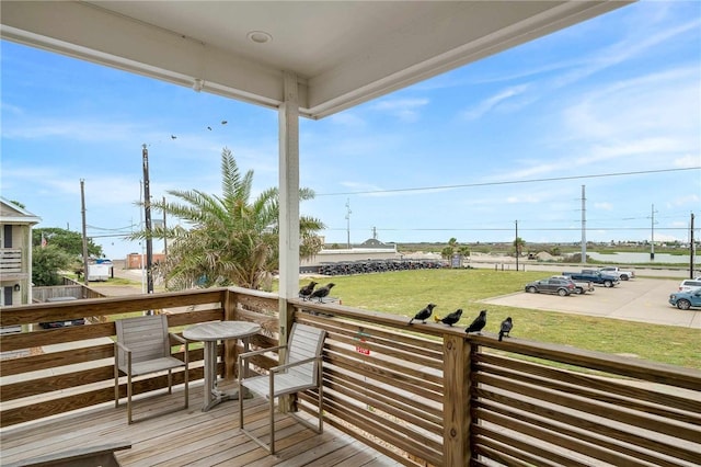 wooden deck featuring a yard