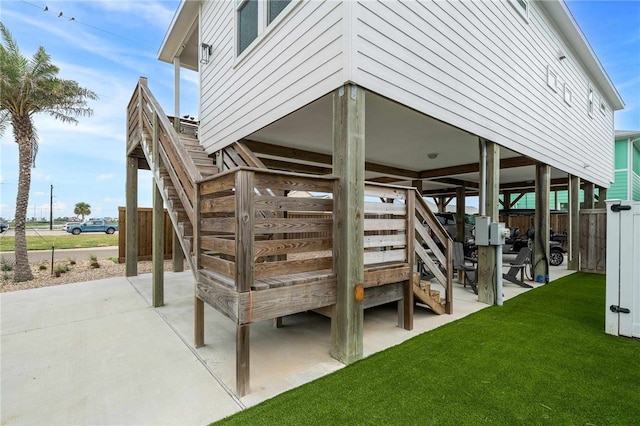 wooden terrace featuring a lawn