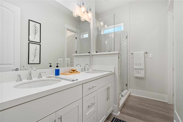 bathroom with vanity, hardwood / wood-style floors, and an enclosed shower