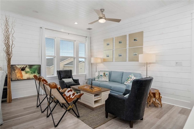 living room featuring ceiling fan, wooden ceiling, and light hardwood / wood-style floors