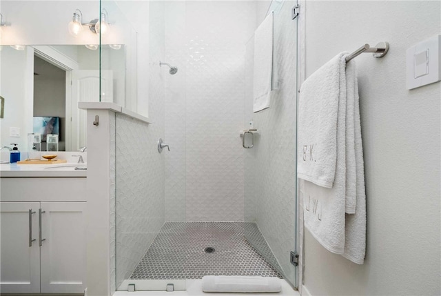 bathroom with vanity and a shower with shower door