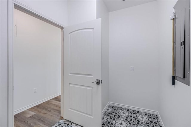 interior space featuring electric panel and light hardwood / wood-style floors