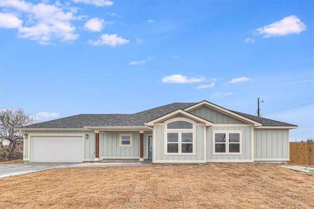 single story home with a garage and a front yard