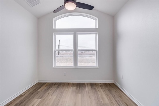 empty room featuring ceiling fan, lofted ceiling, and light wood-type flooring