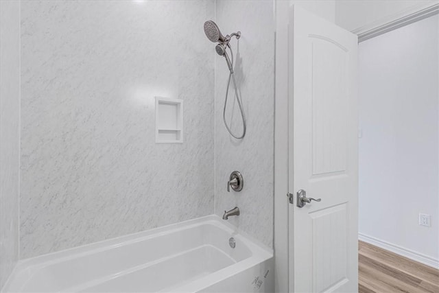 bathroom with tiled shower / bath and wood-type flooring