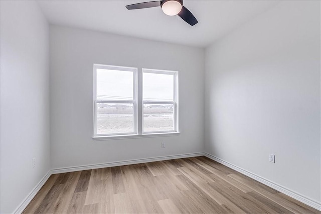 empty room with ceiling fan and light wood-type flooring