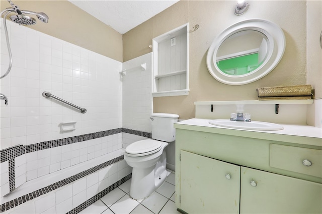 bathroom with tile patterned flooring, radiator, a tile shower, vanity, and toilet