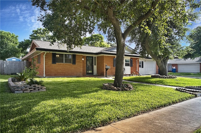 ranch-style home featuring a front yard and a garage