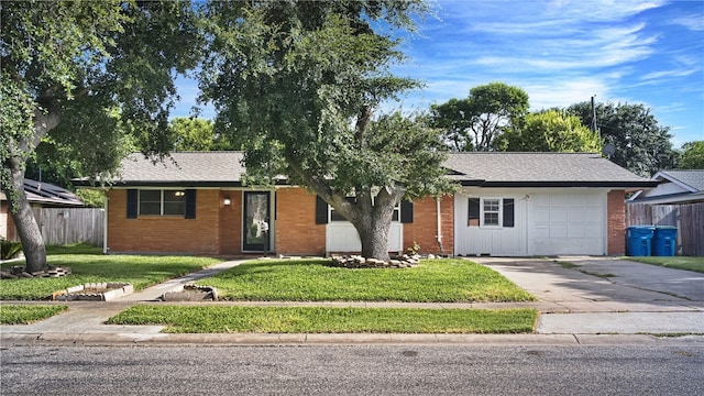 ranch-style home featuring a garage and a front yard