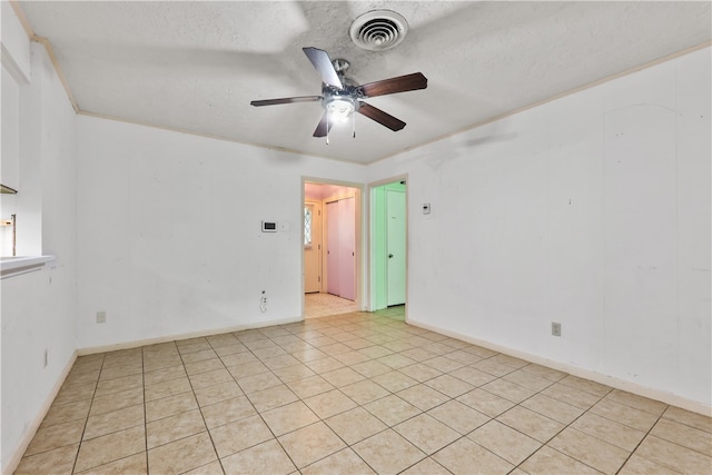 tiled spare room with ceiling fan and a textured ceiling