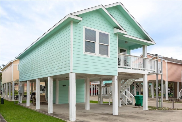 1549 S Commercial St Unit 8, Aransas Pass, TX 78336 - rear view of property featuring a carport, stairway, and driveway