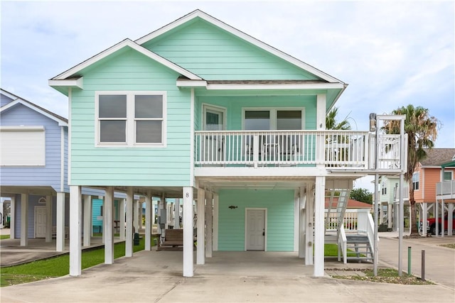 1549 S Commercial St Unit 8, Aransas Pass, TX 78336 - coastal home featuring a carport, concrete driveway, and stairs