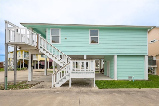 1549 S Commercial St Unit 8, Aransas Pass, TX 78336 - rear view of house with stairs, a carport, and cooling unit