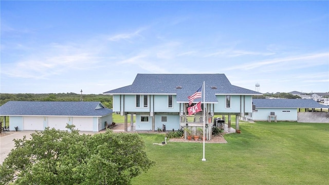 178 Smyth St, Port Oconnor, TX 77982 - split foyer home with an outdoor structure, a front yard, a shingled roof, a detached garage, and driveway