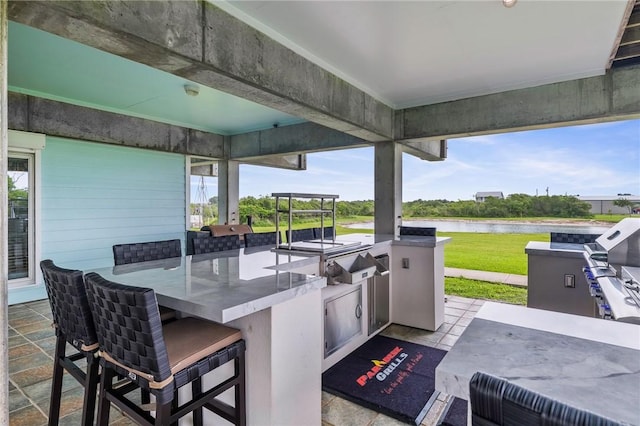 178 Smyth St, Port Oconnor, TX 77982 - view of patio with a water view and an outdoor kitchen