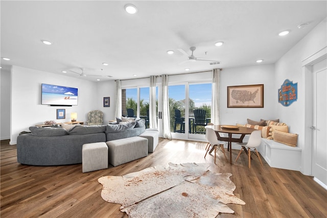 living room featuring ceiling fan and wood-type flooring