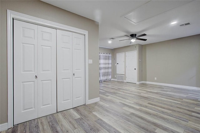 2111 Buckeye Dr, Ingleside, TX 78362 - unfurnished bedroom featuring attic access, light wood-style flooring, baseboards, a ceiling fan, and recessed lighting