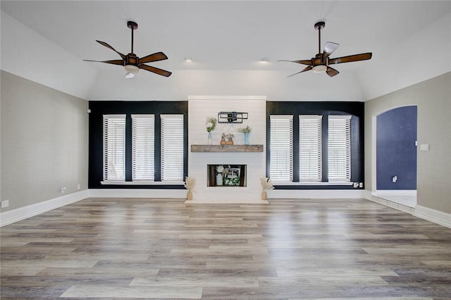 2111 Buckeye Dr, Ingleside, TX 78362 - unfurnished living room featuring ceiling fan, lofted ceiling, healthy amount of natural light, and wood finished floors