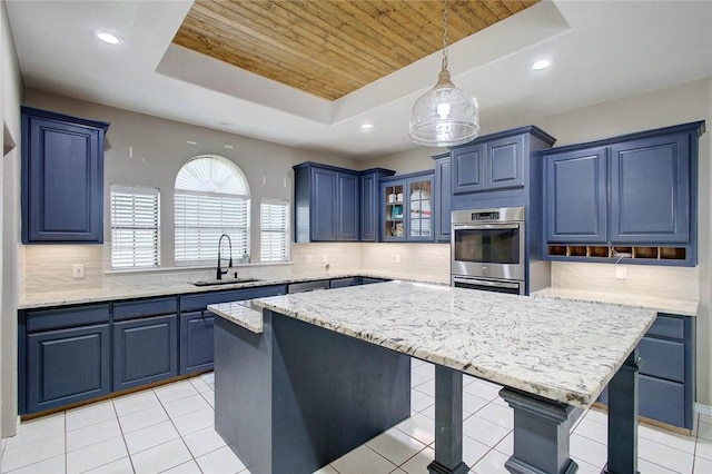 2111 Buckeye Dr, Ingleside, TX 78362 - kitchen with a sink, blue cabinetry, wooden ceiling, a raised ceiling, and a kitchen breakfast bar