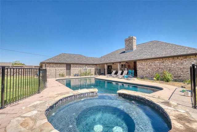 view of swimming pool with an in ground hot tub and a patio area