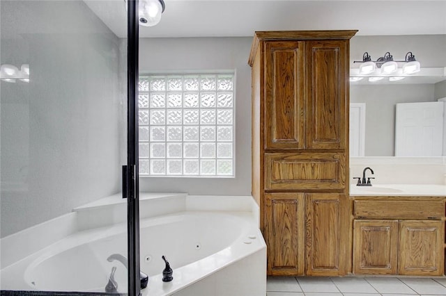 2111 Buckeye Dr, Ingleside, TX 78362 - bathroom featuring tile patterned flooring, a whirlpool tub, and vanity