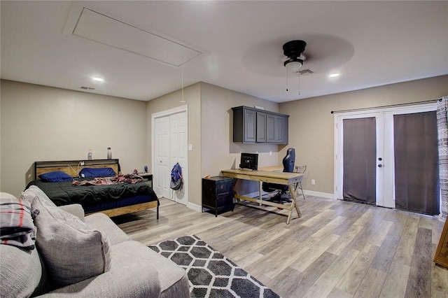 2111 Buckeye Dr, Ingleside, TX 78362 - bedroom featuring attic access, light wood-style flooring, a desk, baseboards, and a ceiling fan