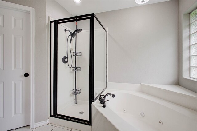 bathroom with tile patterned floors and separate shower and tub