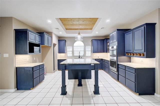 2111 Buckeye Dr, Ingleside, TX 78362 - kitchen with a sink, a raised ceiling, tasteful backsplash, stainless steel double oven, and pendant lighting