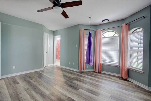 spare room with ceiling fan and light hardwood / wood-style floors