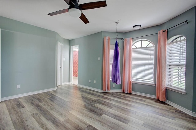 2111 Buckeye Dr, Ingleside, TX 78362 - spare room featuring a ceiling fan, wood finished floors, and baseboards