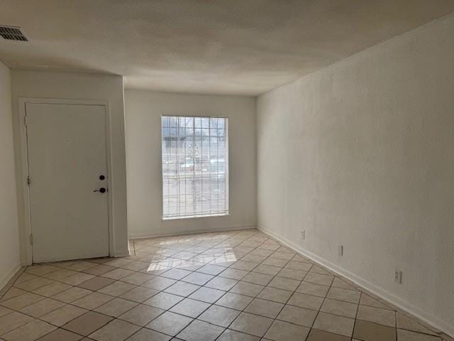 empty room featuring light tile patterned floors