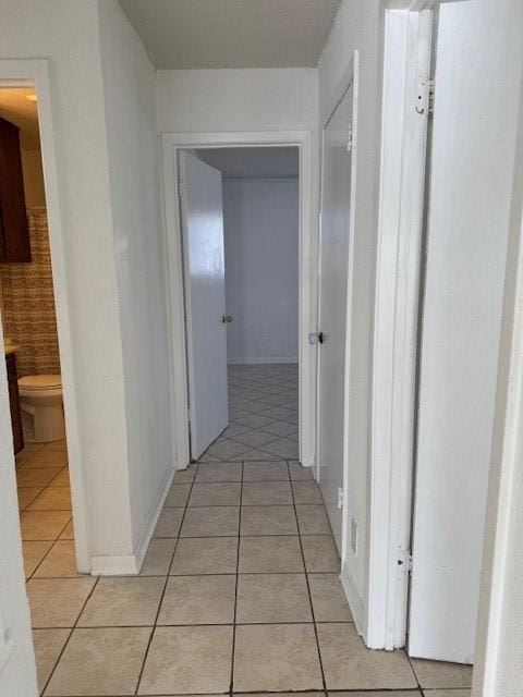 hall with light tile patterned floors