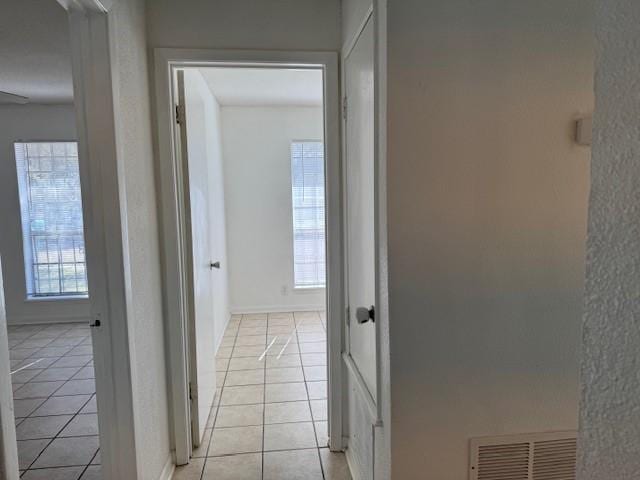 corridor with light tile patterned flooring