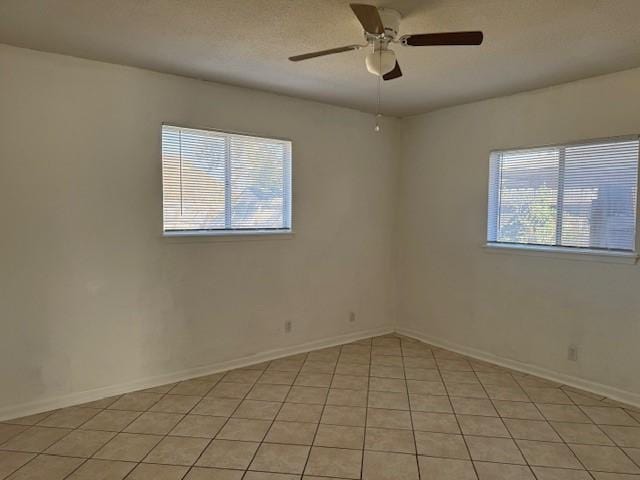 unfurnished room featuring ceiling fan and a wealth of natural light