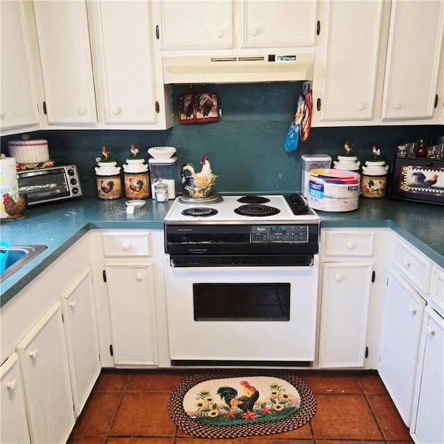 4305 Catfish Dr, Corpus Christi, TX 78410 - kitchen with white electric stove, under cabinet range hood, white cabinetry, and dark tile patterned flooring