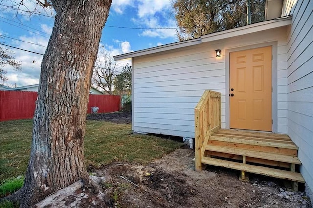 view of outdoor structure with entry steps and fence