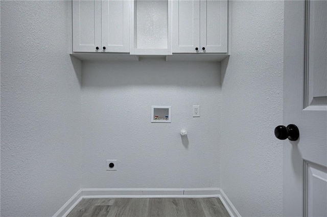4330 Valdez Dr, Corpus Christi, TX 78416 - laundry area with cabinet space, hookup for an electric dryer, wood finished floors, and hookup for a washing machine