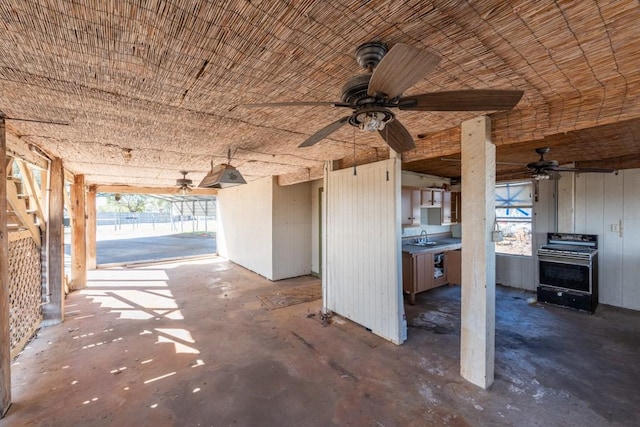 view of patio / terrace with ceiling fan and sink