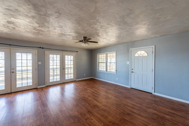 foyer entrance featuring french doors, dark hardwood / wood-style floors, and ceiling fan