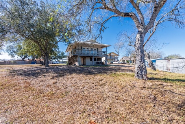 back of house featuring a yard and a wooden deck