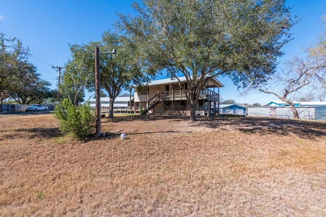 rear view of house featuring a lawn