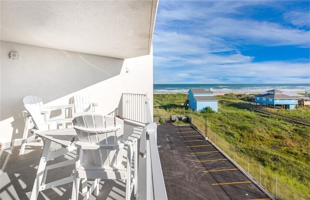 balcony with a beach view and a water view