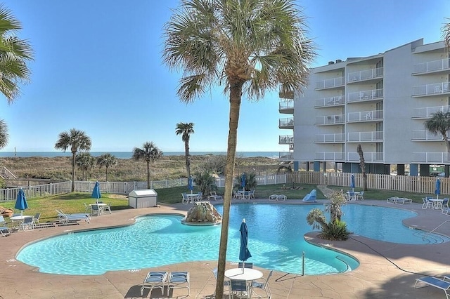 view of swimming pool featuring a yard and a patio area