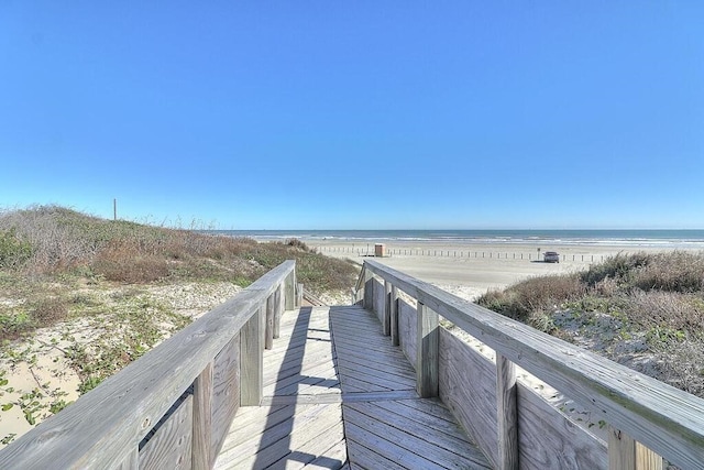 surrounding community featuring a view of the beach and a water view