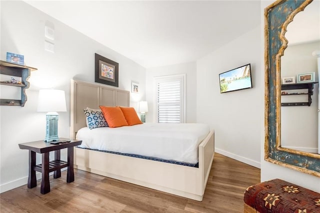 bedroom with hardwood / wood-style floors