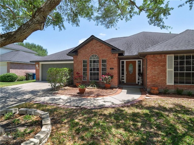 ranch-style house featuring a garage, roof with shingles, concrete driveway, and brick siding