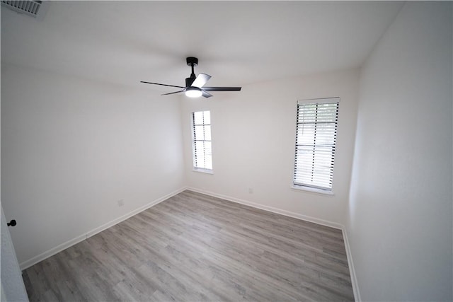 spare room with ceiling fan and light hardwood / wood-style flooring