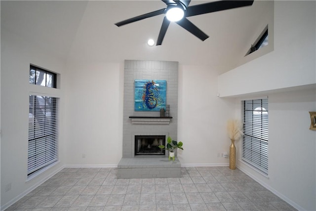 unfurnished living room featuring a fireplace, high vaulted ceiling, and ceiling fan