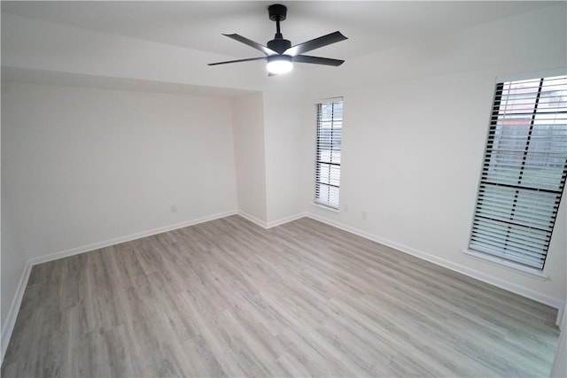 unfurnished room with ceiling fan, plenty of natural light, and light hardwood / wood-style flooring