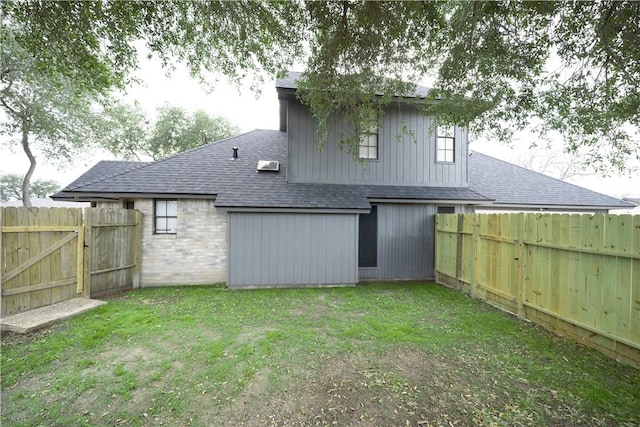 rear view of property with a yard